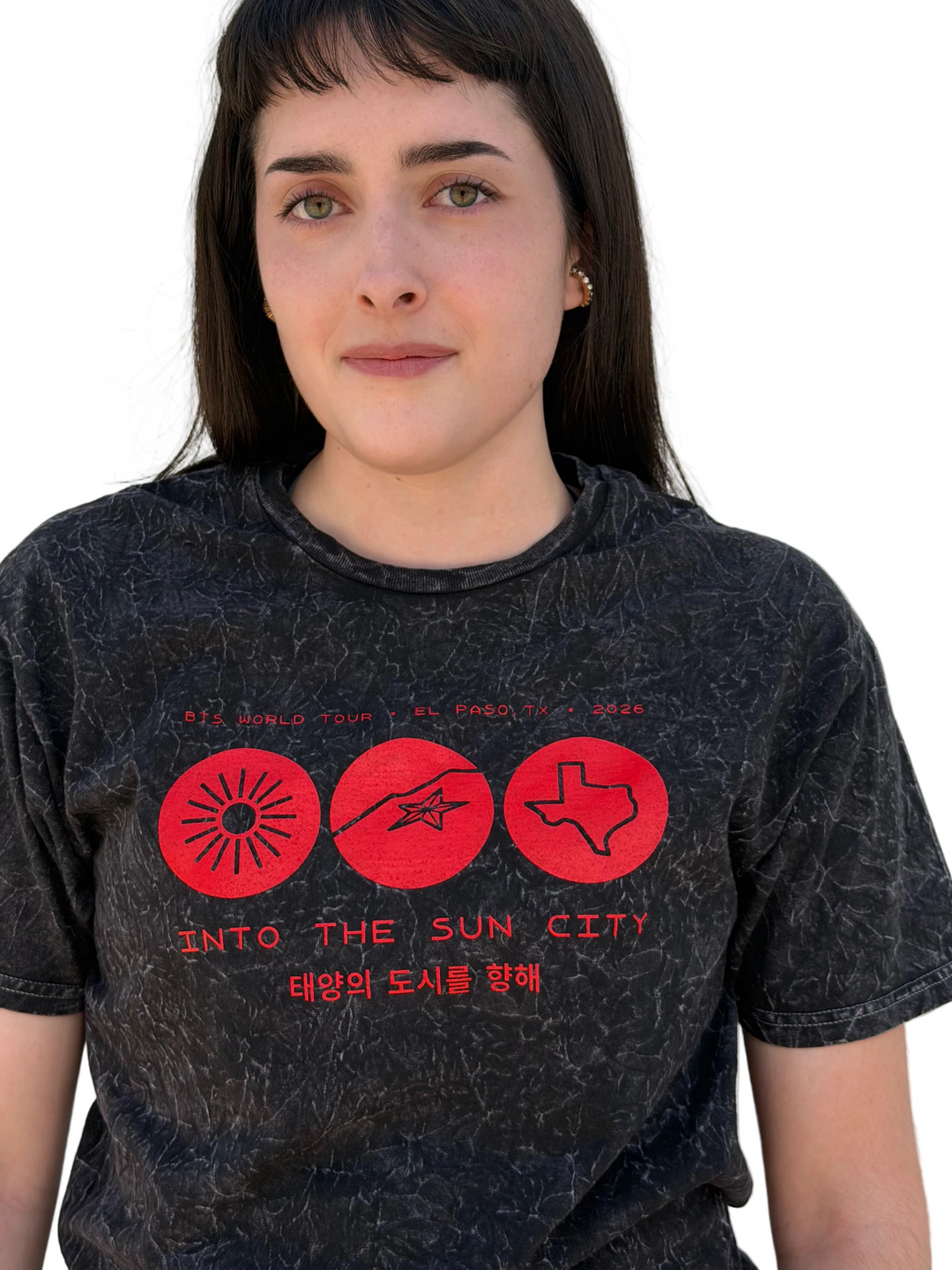 Person wearing a black t-shirt with red graphics and text against a white background