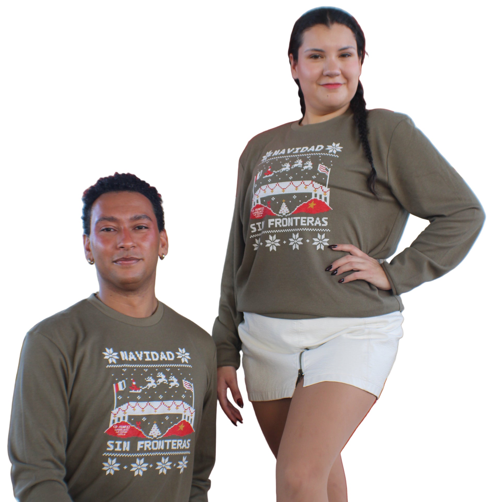 Two people wearing matching green long sleeves with a red and white design that says navidad sin fronteras